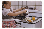Girl Preparing Breakfast in Kitchen by Anonymous