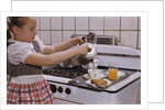 Girl Preparing Breakfast in Kitchen by Anonymous