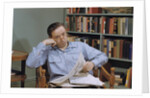 Man Holding Newspaper While Thinking by Anonymous