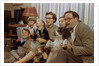 Family Sitting on Couch Together by Anonymous