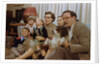 Family Sitting on Couch Together by Anonymous