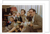 Family Sitting on Couch Together by Anonymous