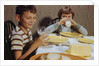 Children Drinking Milk at Dinner Table by Anonymous