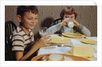 Children Drinking Milk at Dinner Table by Anonymous