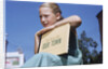 Girl Holding Town History Book by Anonymous
