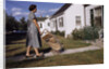 Woman Pushing Shopping Cart to House by Corbis