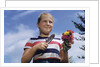 Girl Holding Cut Flowers by Anonymous