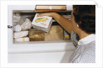 Woman Holding Box of Frozen Corn by Anonymous