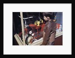 Boy Window Shopping at a Toystore by Anonymous