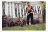 Boy Unhappily Mowing Lawn by Anonymous