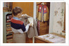 Boy Brushing His Suit Jacket by Anonymous