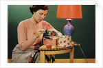Woman Darning Socks by Anonymous