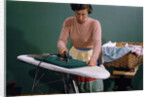 Woman Ironing at Home by Anonymous