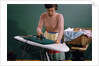 Woman Ironing at Home by Anonymous