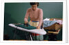 Woman Ironing at Home by Anonymous