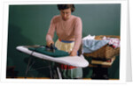 Woman Ironing at Home by Anonymous