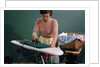 Woman Ironing at Home by Anonymous