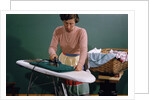 Woman Ironing at Home by Anonymous