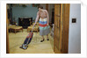 Woman Vacuuming Living Room by Anonymous