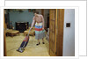 Woman Vacuuming Living Room by Anonymous