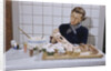 Woman Decorating Cup Cakes by Anonymous