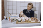 Woman Decorating Cup Cakes by Anonymous