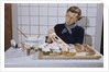 Woman Decorating Cup Cakes by Anonymous