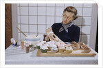 Woman Decorating Cup Cakes by Anonymous