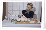 Woman Decorating Cup Cakes by Anonymous
