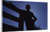 Silhouette of Boy Leaning Against Fence by Anonymous