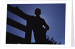 Silhouette of Boy Leaning Against Fence by Anonymous