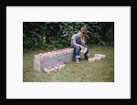 Bored Child Sitting with Raspberry Cartons by Anonymous