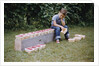 Bored Child Sitting with Raspberry Cartons by Anonymous