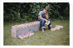 Bored Child Sitting with Raspberry Cartons by Anonymous
