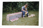 Bored Child Sitting with Raspberry Cartons by Anonymous