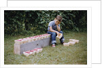 Bored Child Sitting with Raspberry Cartons by Anonymous