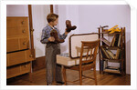 Boy Looking at Cowboy Boots by Anonymous