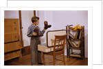 Boy Looking at Cowboy Boots by Anonymous