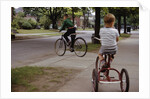 Boys Riding Their Bike and Tricycle by Anonymous
