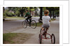 Boys Riding Their Bike and Tricycle by Anonymous