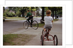 Boys Riding Their Bike and Tricycle by Anonymous