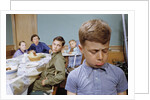 Boy Pouting near the Dinner Table by Anonymous