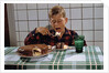 Boy Eating a Slice of Cake by Anonymous