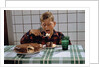 Boy Eating a Slice of Cake by Anonymous