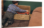 Boy Removing Fire Engine from Toy Chest by Anonymous