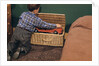Boy Removing Fire Engine from Toy Chest by Anonymous