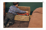 Boy Removing Fire Engine from Toy Chest by Anonymous