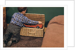 Boy Removing Fire Engine from Toy Chest by Anonymous