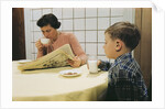 Boy Eating Cookies and Milk as Mom Reads by Anonymous
