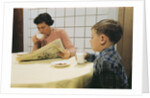 Boy Eating Cookies and Milk as Mom Reads by Anonymous